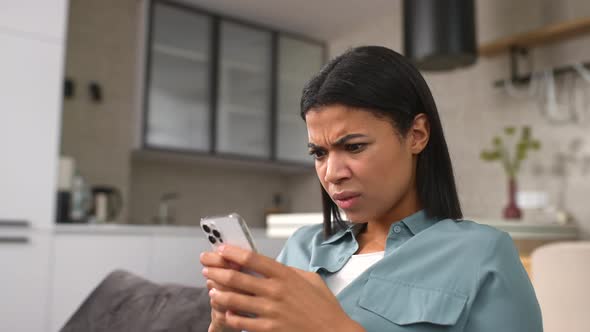 Confused Woman Looking at Smartphone Screen Feeling Depressed About Bad News Notification