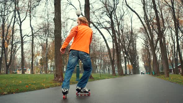 Professional Bearded Male Roller Skater Does Various Difficult Tricks and Turns, Showing Active