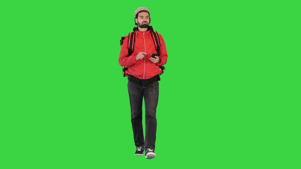 Delivery Courier Searching for Customer's Address While Walking on a Green Screen Chroma Key