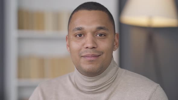 Wealthy Successful Young African American Man with Brown Eyes Posing at Home Looking at Camera