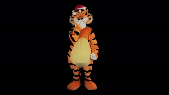 Man in Tiger Costume with Santa's Red Hat Yawns and Closes His Mouth with Paw
