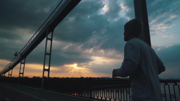 Guy Runs in the City in Cloudy Weather