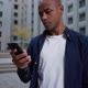Ethnic Man Using Smartphone on Street - VideoHive Item for Sale