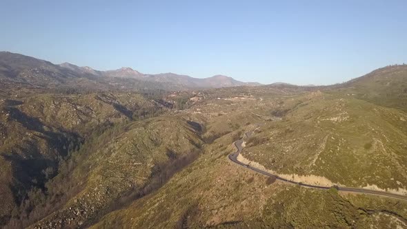 Drone flying high over mountain pass road