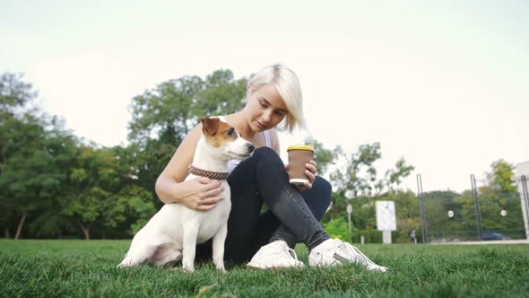 Young Woman with Little Cute Jack Russel Terrier in Park