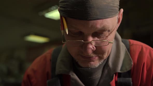 A Carpenter Works in a Woodworking Workshop at a Furniture Factory