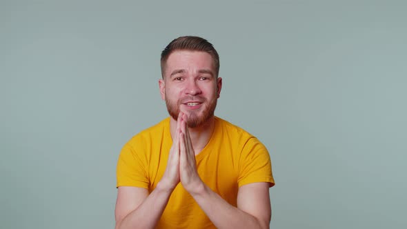 Trendy Young Adult Man Praying Looking Upward and Making Wish Asking God for Help Begging Apology