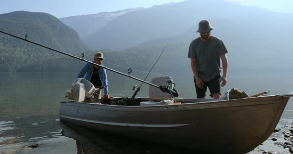Two fishermen preparing for fishing in the river 4k