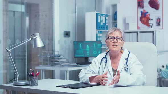 Authentic Experienced Old Woman Doctor Talking To the Camera