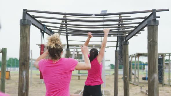 Caucasian woman exercising at bootcamp