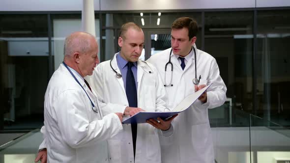 Team of doctors discussing over medical report