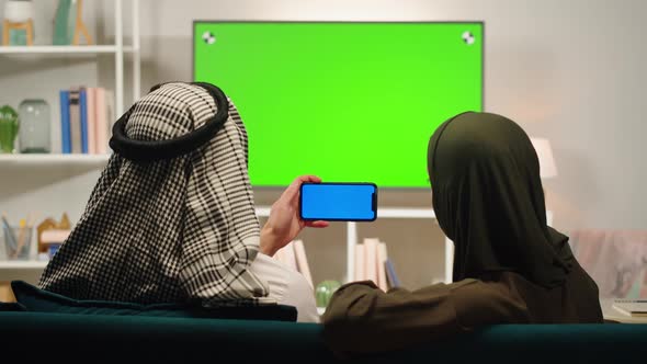 Middle Eastern Family Using Phone with Chroma Key Closeup Watching Video or Film
