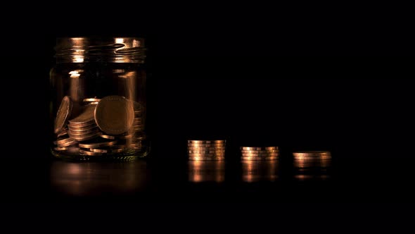 Stop motion of Stack of golden coins in bar chart form on black background