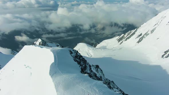 Snowy Summit of Mountain in European Alps. Aerial View