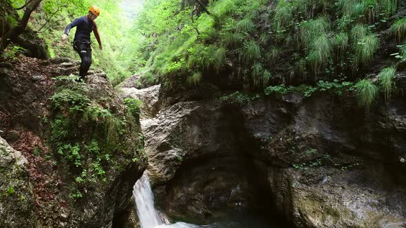 Aerial view of child jumping into the water in Soca river, Slovenia