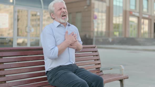 Old Man Having Heart Pain While Sitting on Bench Outdoor