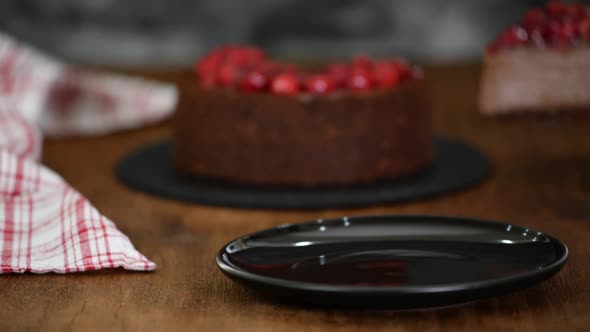 Delicious Piece Of Chocolate Cheesecake with cherry.	