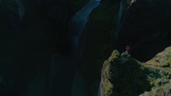 Epic Cinematic Shot of Man on Edge of Cliff Rock
