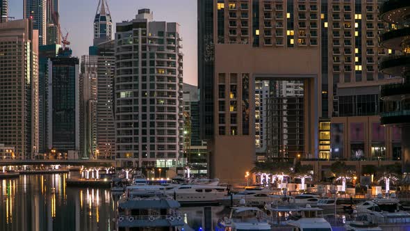 View of Dubai Marina Towers and Canal in Dubai Night to Day Timelapse
