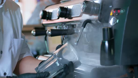 Young Barista in Gloves Processes Transparent Glass Glasses for Cocktails with Help of Hot Steam