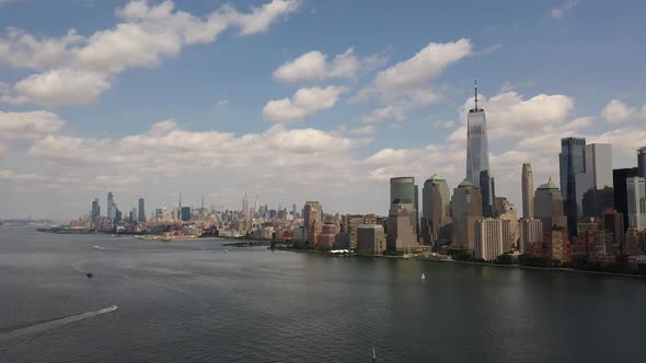 A bird's eye view over Upper Bay with water vesselsing by in the Hudson River below. The drone truck