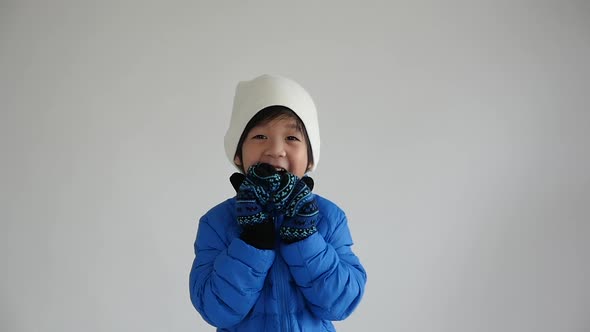 Cute Asian Child In Blue Winter Clothes Open Palm Hands Slow Motion