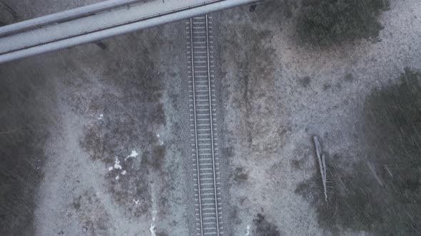 AERIAL: Top View of Overpass Bridge with Railway on a Snowstorm