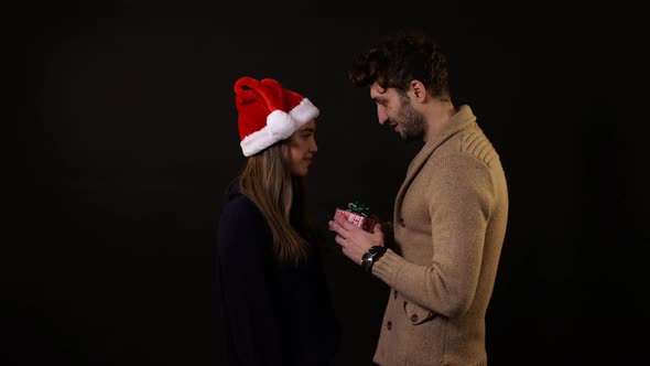 A young man giving a present to a girl