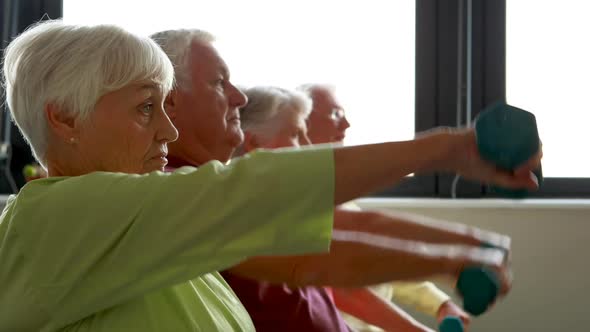 Senior citizens exercising with dumbbells