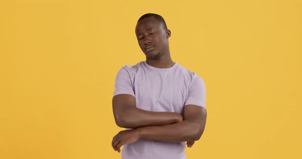 Offended African American Guy Folding Arms and Pouting Lips To Camera