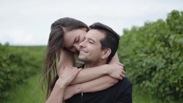 Happy Girl Embraces Her Lovely Man Behind Him on Green Path