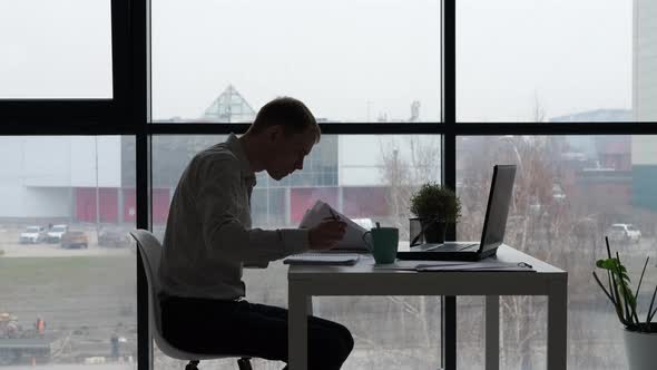 Silhouette of Male Entrepreneur Working in Office