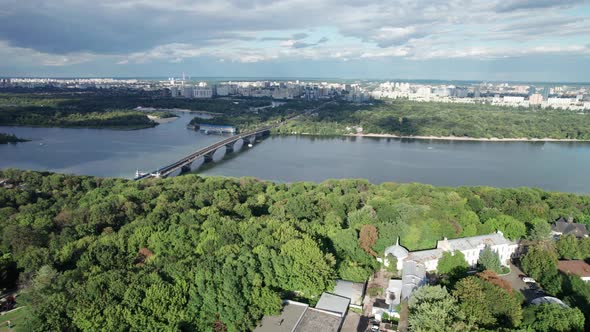 Aerial View of the City Skyline with a Bridge Over the River and Green Nature