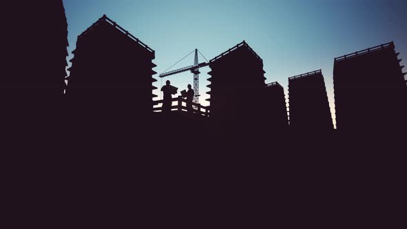 Construction Worker Looking At Blueprints Silhouettes alt