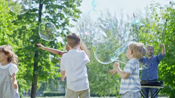 Kids at Soap Bubbles Party in Park