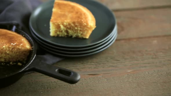 Slice of sweet cornbread with honey on the plate