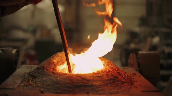 Foundry, Steel Industry, Worker Mixes Liquid Metal in Furnace, Flame, Remelting Steel