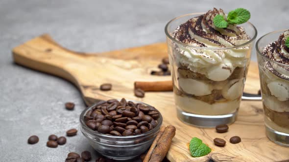 Classic Tiramisu Dessert in a Glass on Dark Concrete Background