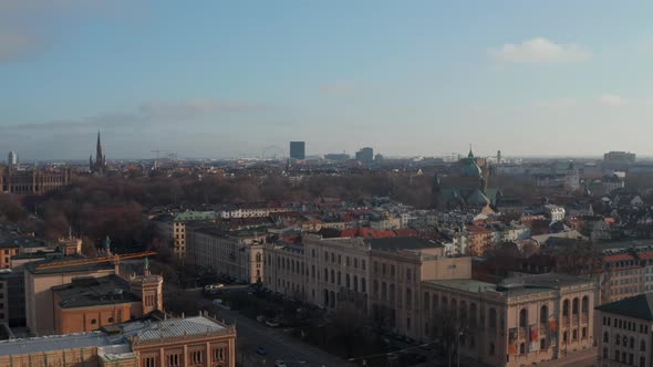 Towards St. Lukas Church Cathedral with Green Roof Towers in Beautiful Munich, Germany, Aerial Dolly