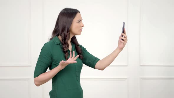 Sad Indian girl talking on a video call