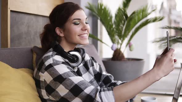 Closeup of Woman Looking at Front Phone Camera Searching Best Pose for Selfie Portrait