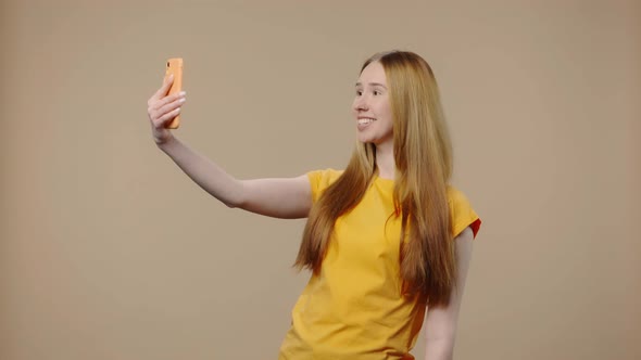 Portrait of Model with Natural Beauty is Talking on a Video Call Using a Smartphone