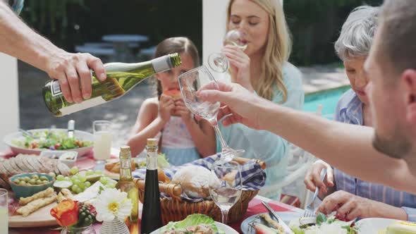 Happy family eating together at table