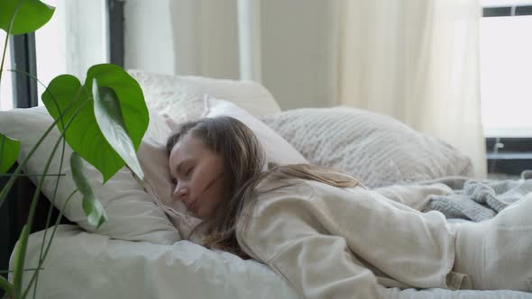 Tired Woman Falls Down in the Pillow