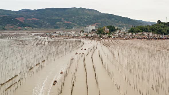 Aerial shot of fishermen heading out to sea on the coast of China