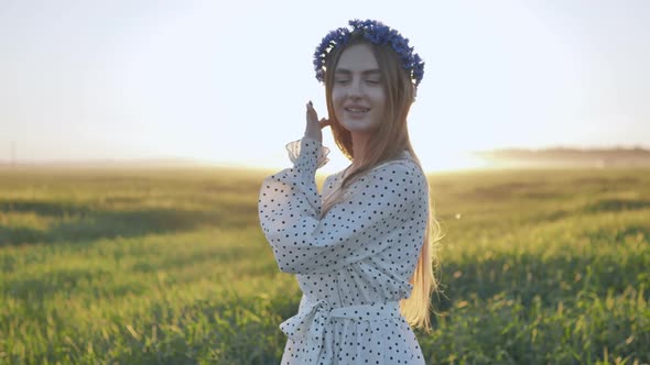 A Cute Ukrainian Girl Posing in a Field in the Evening