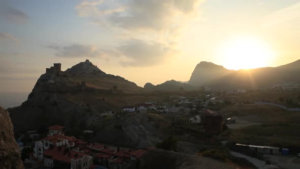 Ancient Genoese Fortress in Sudak Town. Panorama View at Sunset. Crimea.