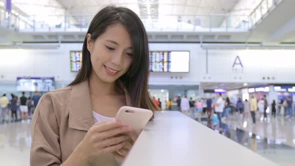 Travel woman using mobile phone in the airport