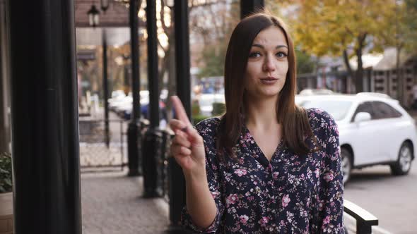 Close-up Portrait of Young Woman Say No By Shaking Head and Wagging Her Finger, Rejecting Gesture