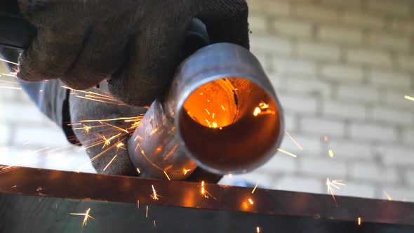 Close Up of Metal Processing with Circular Saw. Hands of Mechanic Holding Instrument and Grinding